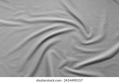 Stylish suiting fabric with textured pattern made from natural fibers. Light gray textile background with soft folds. Sewing comfortable, fashionable clothes. Flat lay, close-up, top view, copy space