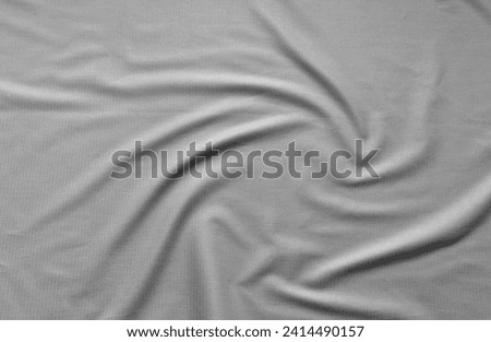 Stylish suiting fabric with textured pattern made from natural fibers. Light gray textile background with soft folds. Sewing comfortable, fashionable clothes. Flat lay, close-up, top view, copy space