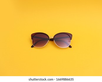 Stylish Sun Glasses On Yellow Background, Top View