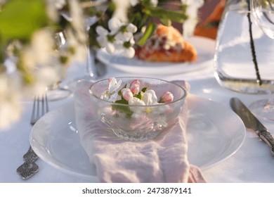 Stylish table setting with beautiful spring flowers in garden - Powered by Shutterstock