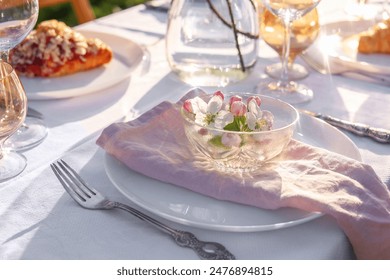 Stylish table setting with beautiful spring flowers in garden - Powered by Shutterstock