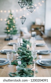 Stylish Table Setting For Christmas Family Dinner With Christmas Tree On The Background.