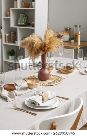 Stylish table setting for dinner in kitchen