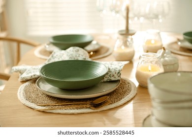 Stylish table setting with dishware, cutlery and burning candles indoors
