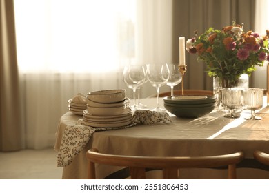 Stylish table setting with dishware, glasses and beautiful flowers indoors