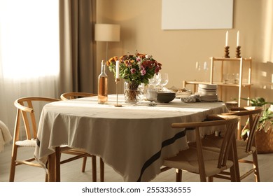 Stylish table setting with dishware, glasses and beautiful flowers indoors