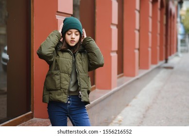 stylish teen girl outdoors in a hat and jacket - Shutterstock ID 1556216552