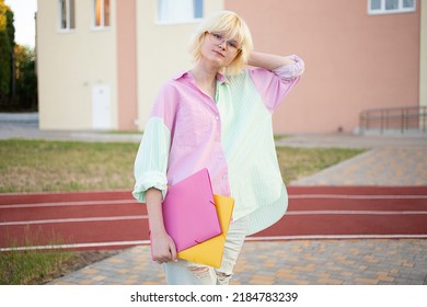 Stylish Teenage Girl With Folders In Her Hands.Staying Near School Or College,ready For Education.