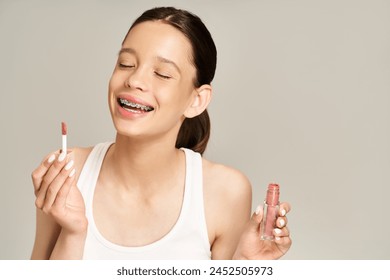 A stylish teenage girl in vibrant attire confidently holds lipstick. - Powered by Shutterstock