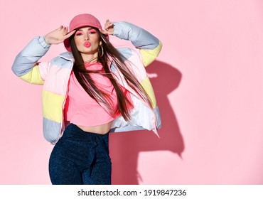 Stylish Teenager Girl Model With Kissing Lips Posing For Camera Beauty Studio Portrait Isolated On Pink Background. Chic Young Woman Wearing Jacket, T-shirt And Hat. Teenage And Youth Fashion