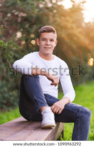 Image, Stock Photo Stylish teenager sitting on a wooden bench