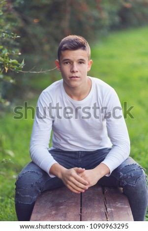 Similar – Image, Stock Photo Stylish teenager sitting on a wooden bench