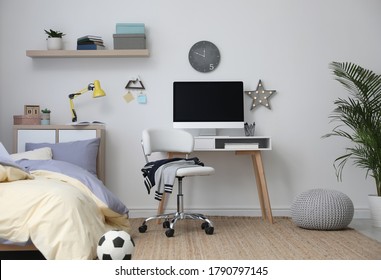 Stylish teenager's room interior with comfortable bed and workplace - Shutterstock ID 1790797145