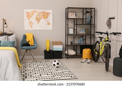 Stylish teenager's room interior with comfortable bed and sports equipment - Shutterstock ID 2137070685