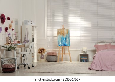 Stylish Teenager's Room Interior With Computer, Comfortable Bed And Painting Easel