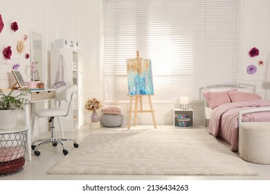 Stylish Teenager's Room Interior With Computer, Comfortable Bed And Painting Easel