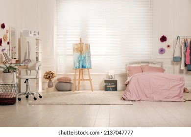 Stylish Teenager's Room Interior With Computer, Comfortable Bed And Painting Easel