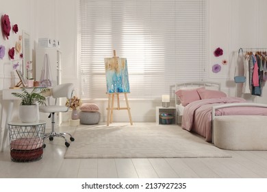 Stylish Teenager's Room Interior With Computer, Comfortable Bed And Painting Easel