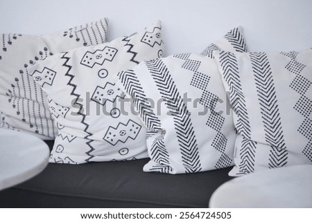 Stylish throw pillows with geometric patterns adorning the sofa beautifully