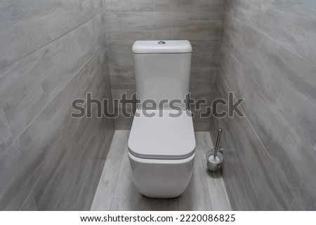 Stylish toilet in modern grey bathroom