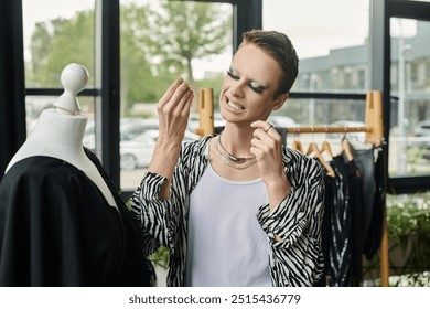 A stylish transgender fashion designer enthusiastically showcases creativity while working in a vibrant studio. - Powered by Shutterstock