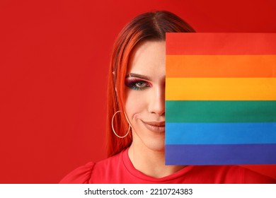 Stylish Transgender Woman With Flag Of LGBT On Red Background