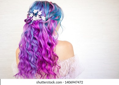 Stylish trendy hairstyle curly blonde hair  Fashionable hair coloring  blue   purple shades 