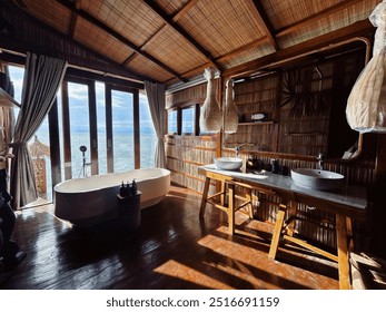 A stylish vanity bathroom featuring a modern bathtub and dual sinks on a marble countertop. Woven walls and large windows provide a calming ocean view, creating a natural and elegant atmosphere. - Powered by Shutterstock