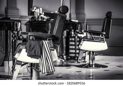  Stylish vintage barber chair. Professional hairstylist in barbershop interior. Barber shop chair. Black and white.