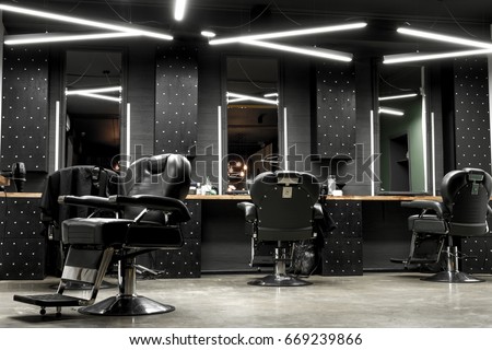 Stylish Vintage Barber Chairs In Black And Grey Interior. Barbershop Theme 