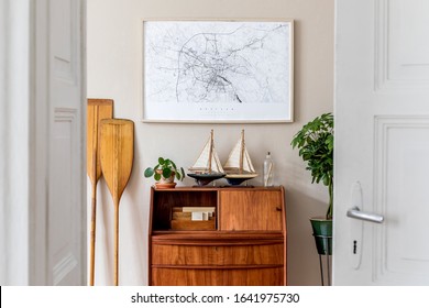 Stylish And Vintage Interior Design Of Living Room With Wooden Retro Commode,  Plants, Ships, Paddle, Map And Elegant Personal Accessories. Mock Up Poster Frame On The Wall. Template. Home Decor.