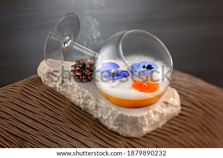 Stylish vodka base cocktail served in a wine glass with edible flowers