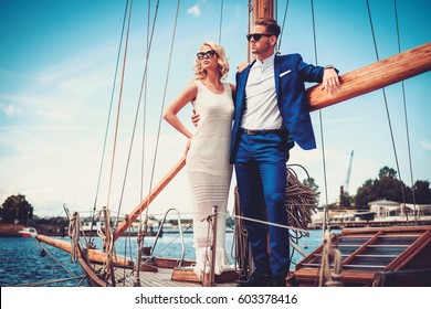 Stylish wealthy couple on a luxury yacht.