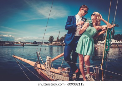 Stylish Wealthy Couple On A Luxury Yacht