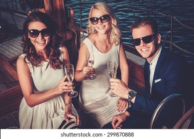 Stylish wealthy friends having fun on a luxury yacht 