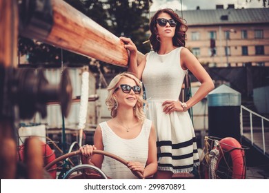 Stylish wealthy women on a luxury yacht 
