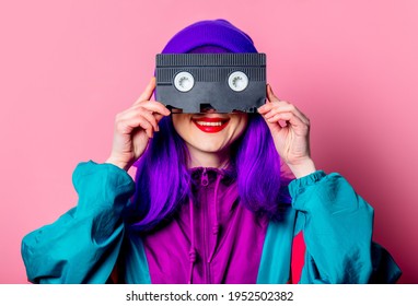 Stylish White Girl With Purple Hair, 80s Tracksuit Hold Video Tape On Pink Background