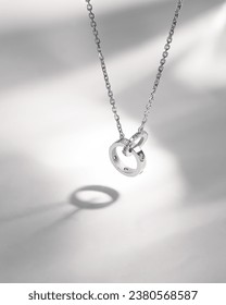 Stylish white gold necklace with diamonds on a white background.       