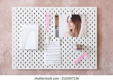 Stylish White Peg Board Hanging On Textured Pink Wall