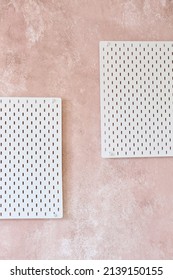 Stylish White Peg Board Hanging On Textured Pink Wall