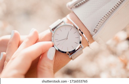 Stylish white watch on woman hand - Shutterstock ID 1716553765