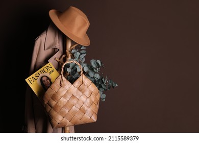 Stylish Wicker Basket, Hat And Coat Hanging On Clothing Rack Near Brown Wall, Space For Text