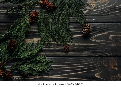 Stylish Winter Flat Lay With Anise Cinnamon And Pine Cones On Green Fir Branches On Rustic Wooden Background. Space For Text. Seasonal Holidays Concept. Greeting Card 