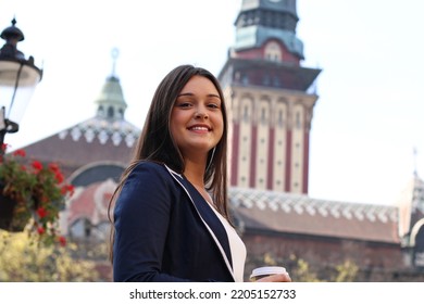 Stylish Woman In A Beautiful European City, Exploring And Drinking A Cup Of Hot Coffee On The Go.