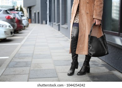 Stylish woman in black shoes on city street