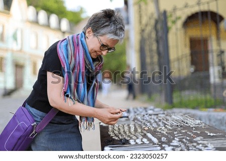 Similar – Image, Stock Photo Twin sisters laughing at a postcard in Erfurt