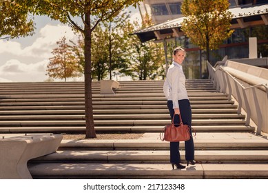 Stylish woman climbing a flight of urban stairs