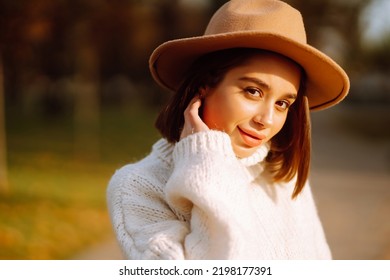 Stylish woman enjoying autumn weather outdoor. Fashion, style concept. People, lifestyle, relaxation and vacations concept. - Shutterstock ID 2198177391