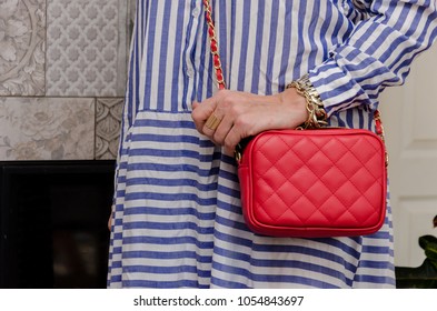 Stylish Woman Of Fashionable Woman Has A Small Quilted Red Leather Bag In Her Hands. Hit Of The Season, Super Cool Thing For Summer