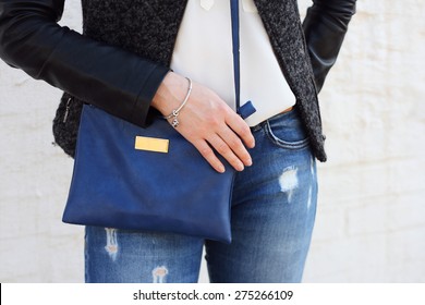 Stylish Woman In Jeans With Small Blue Handbag. 